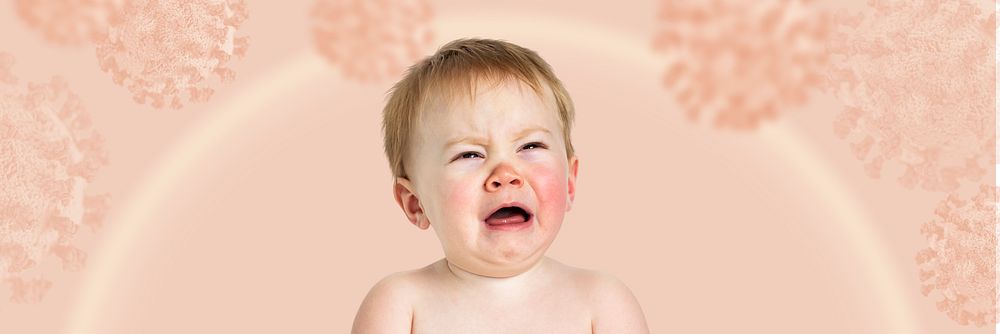 Crying baby on a pink coronavirus contaminated background