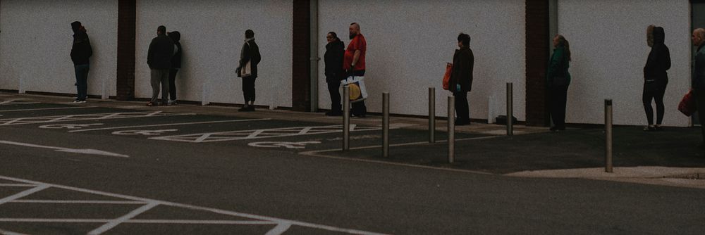 People lining up outside the supermarket social distancing during coronavirus pandemic. MARCH 30, 2020 - BRISTOL, UK