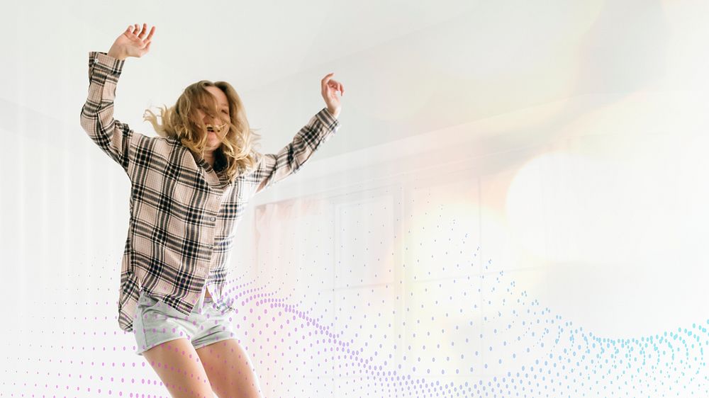 Woman jumping with joy on her bed