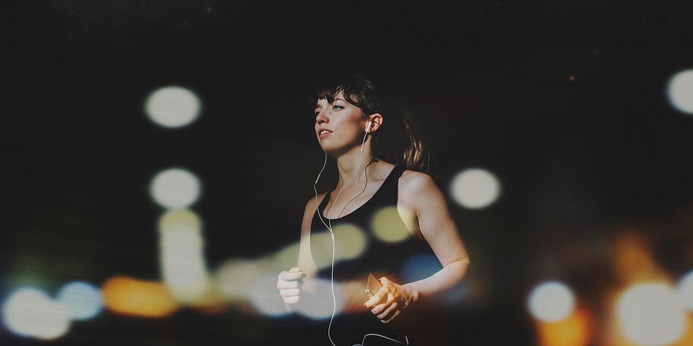 Sporty woman running in a dark alley social banner