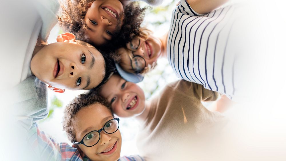 Happy kids huddling in the park