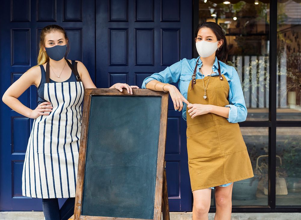 Coffee shop staff in face mask in covid 19 new normal, coronavirus pandemic
