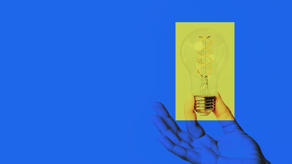Hand holding light bulb idea on blue background