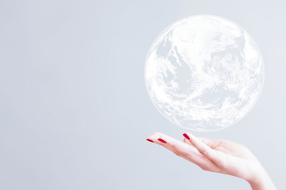 White globe over woman hand gray background