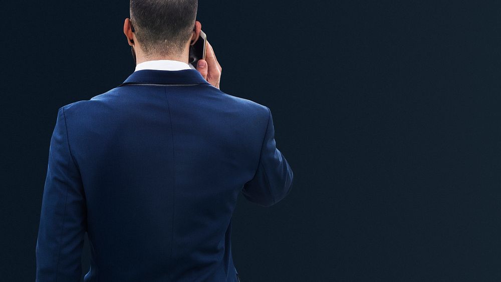 Businessman in blue suit talking on phone