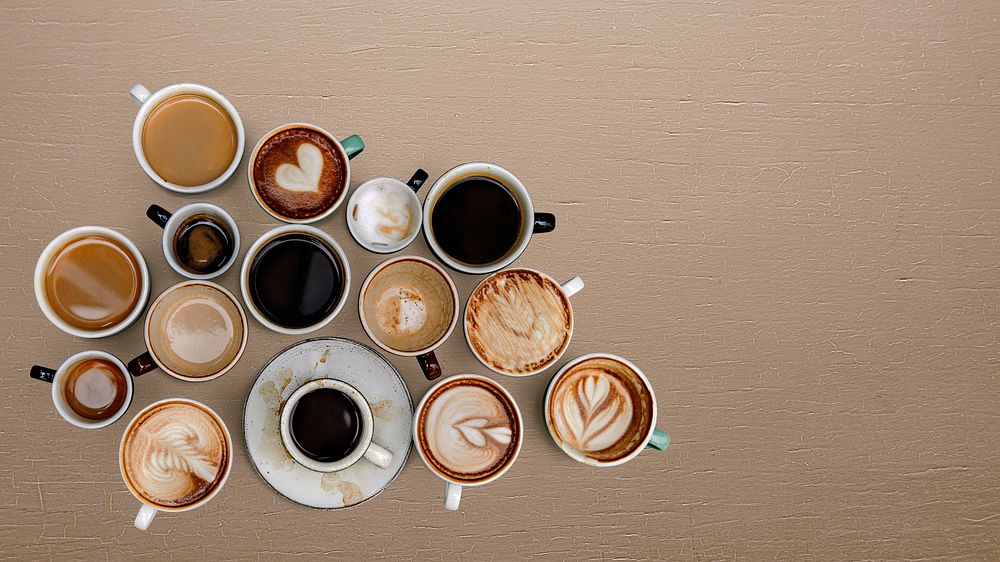 Mixed coffee cups on a beige background