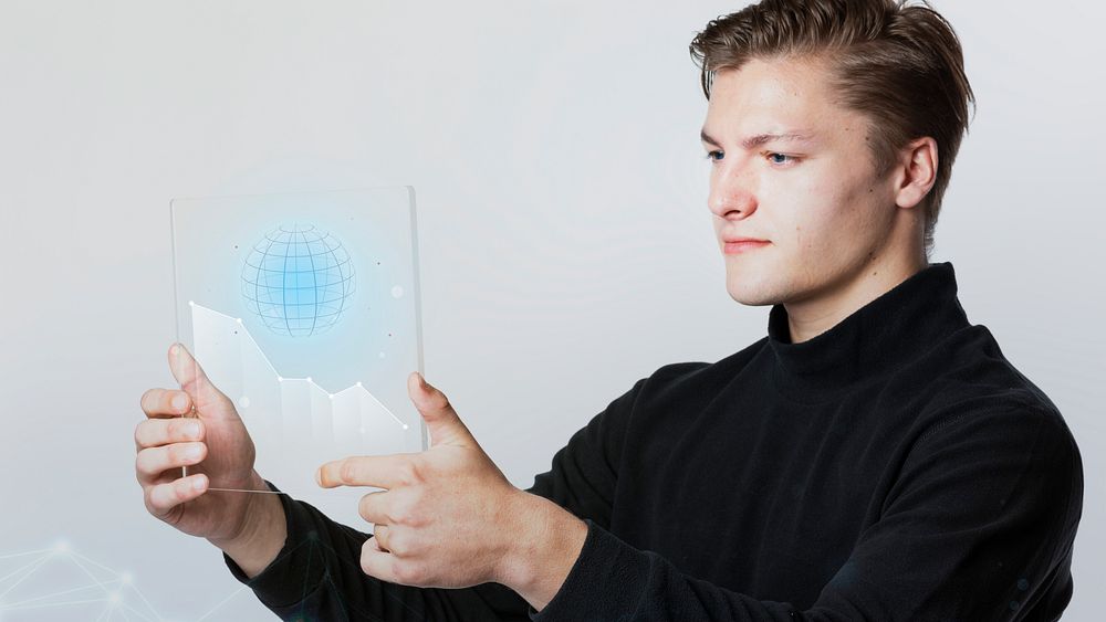 Businessman holding a digital screen that present globe