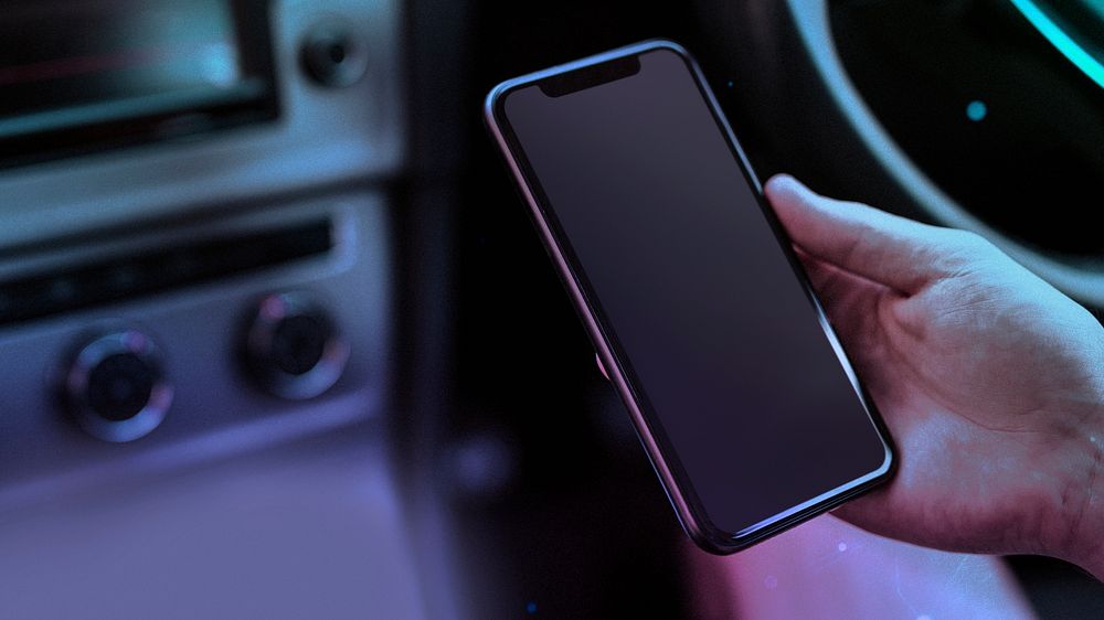 Person using a phone in a smart car blog banner background