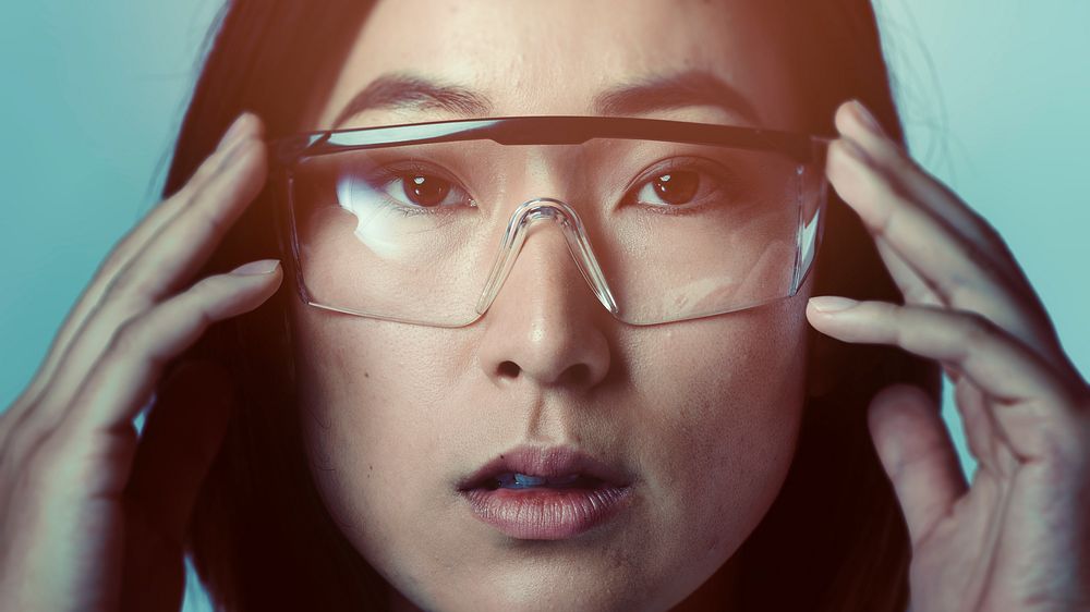 Woman touching AR smart glasses futuristic technology