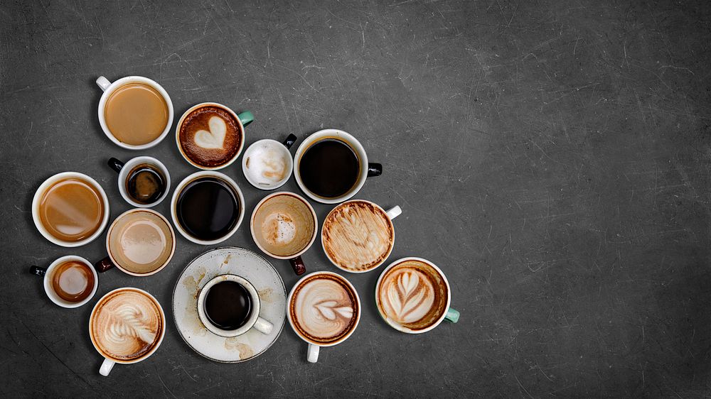 Mixed coffee mugs on a black textured background
