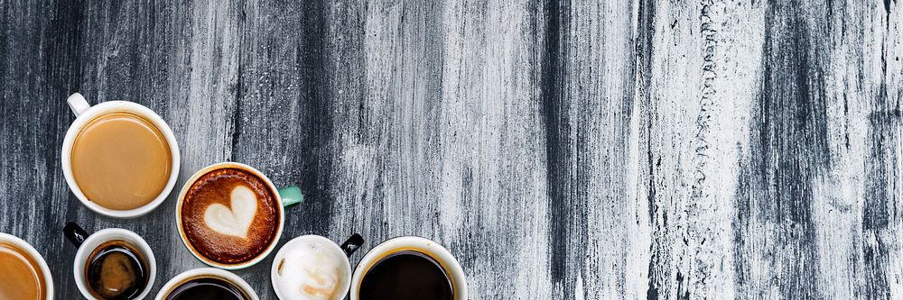 Various coffee mugs on an abstract textured wallpaper