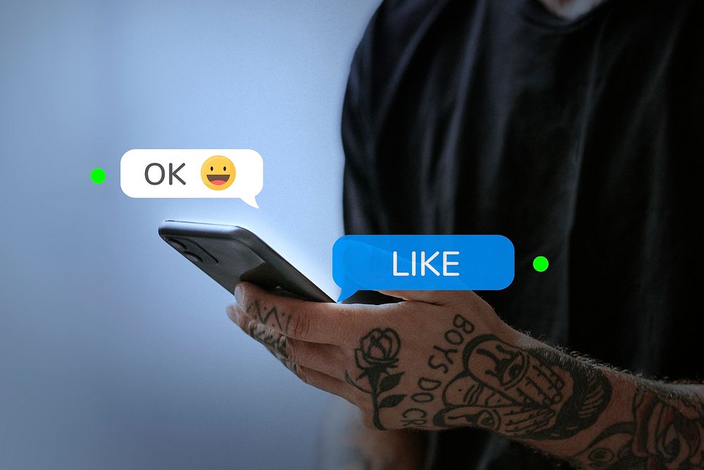 Tattooed man texting friend for social media remix