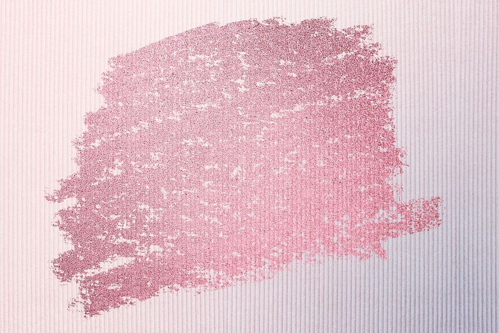Metallic pink oil paint brush stroke texture on a pink fabric textured background