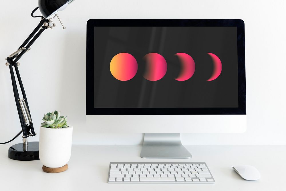 Gradient moon on computer screen, minimal workspace