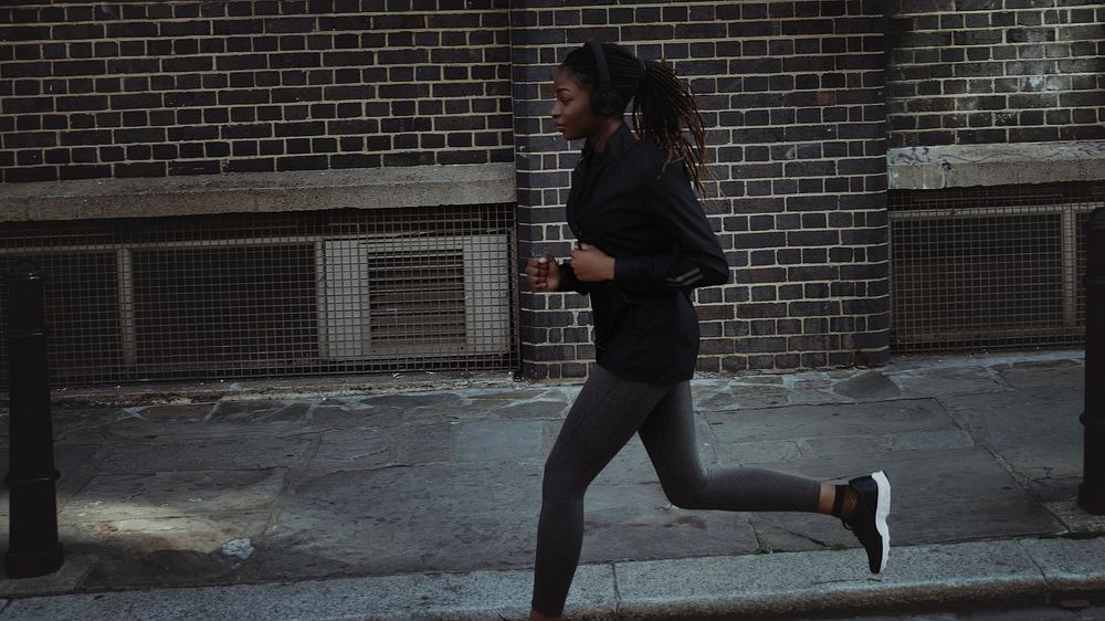 Woman jogging through the city