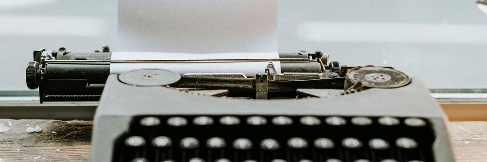 Retro typewriter with a piece of paper mockup website banner template