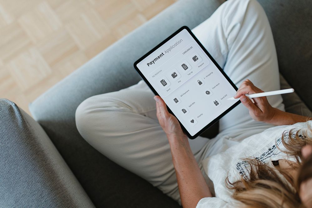 Woman using a stylus with a digital tablet during coronavirus quarantine at home