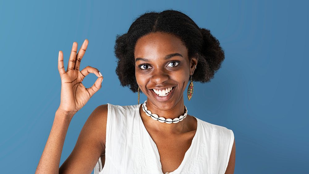 Happy black girl showing an ok hand gesture