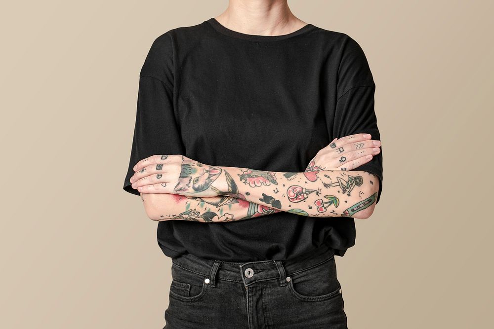 Tattooed model in black t-shirt and jeans