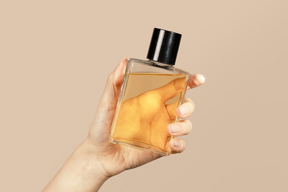 Woman holding a perfume glass bottle psd mockup