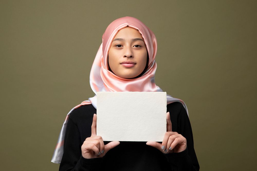 Muslim woman showing a blank card