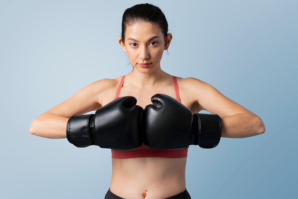 Sportive woman ready to fight on blue background mockup