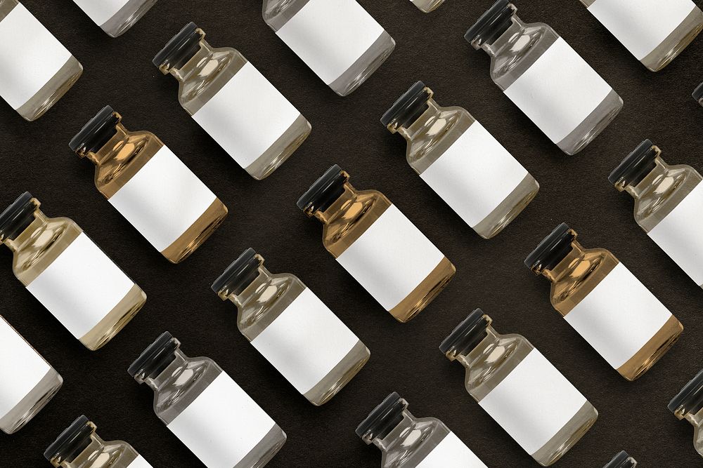 Vitamin injection glass bottles arranged in rows on black background