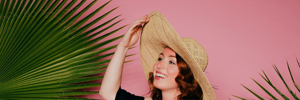 Happy woman wearing a straw hat