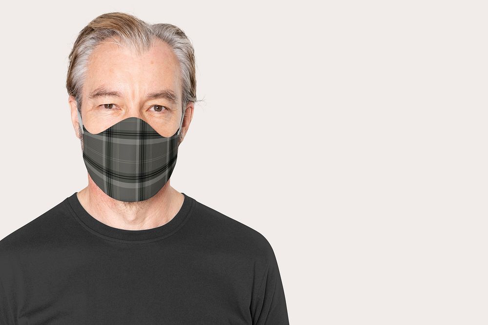 Mature man wearing plaid face mask in the new normal