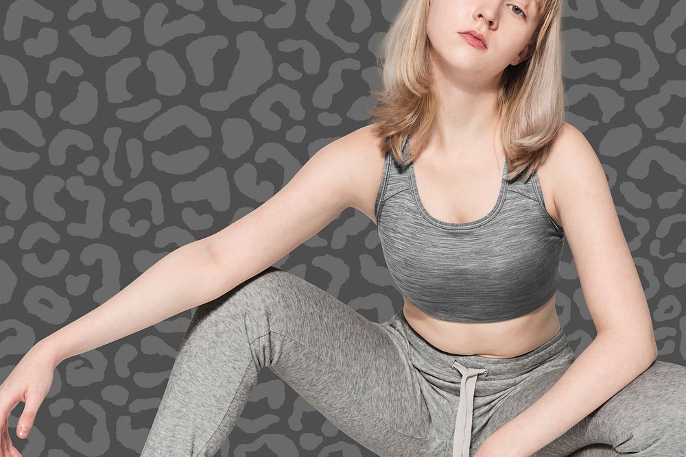 Blonde girl in sports bra and sweatpants on leopard background activewear photoshoot full body 