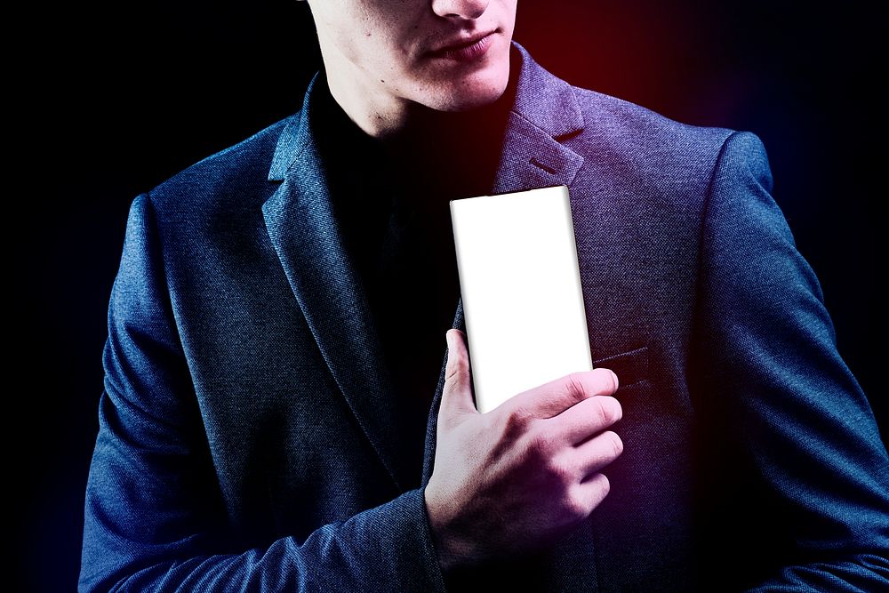 Man in suit holding his mobile phone device