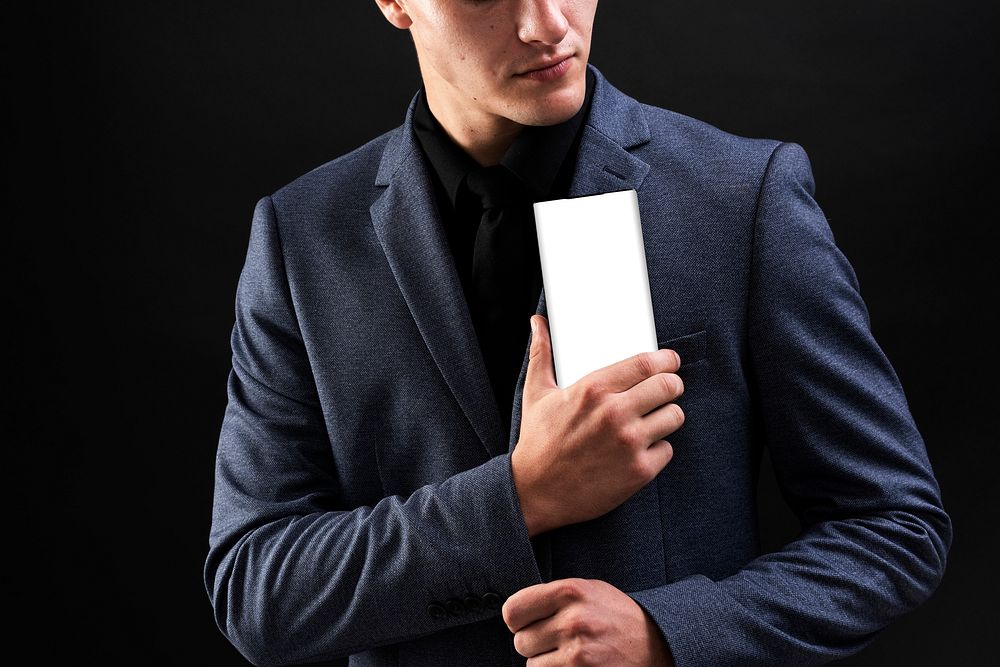 Man in suit holding his mobile phone device