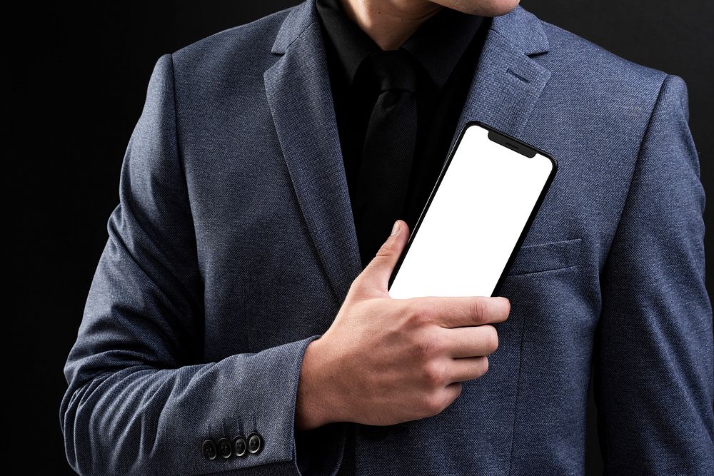 Businessman in suit showcasing futuristic mobile phone technology