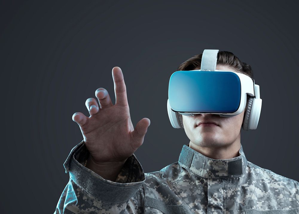 Military in VR headset touching virtual screen