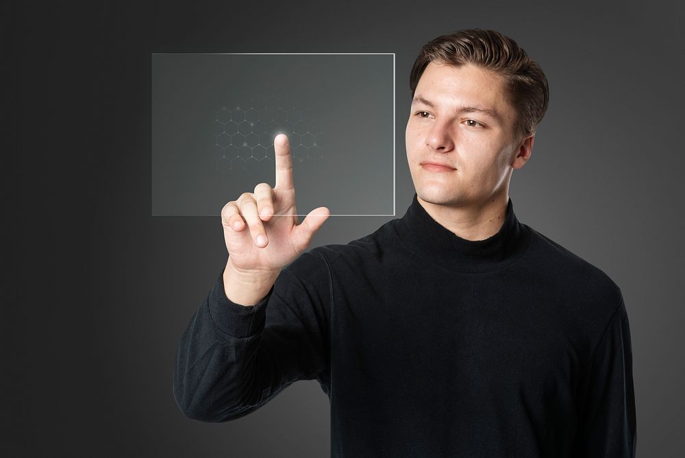 Man pressing finger on virtual screen