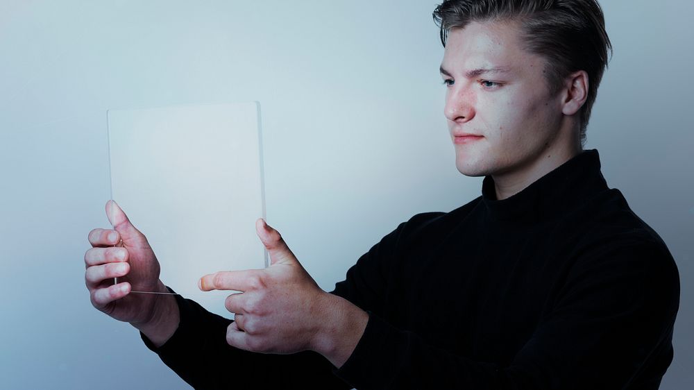 Man using a transparent  tablet digital device