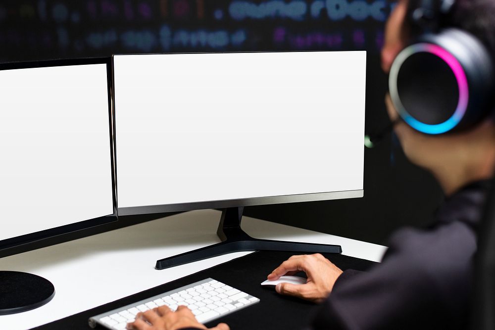 Male IT programmer working on blank screen computer