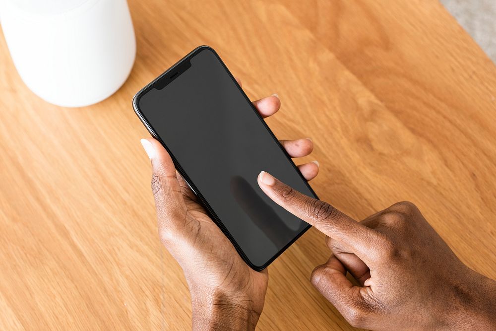 African American woman connecting smart speaker to phone