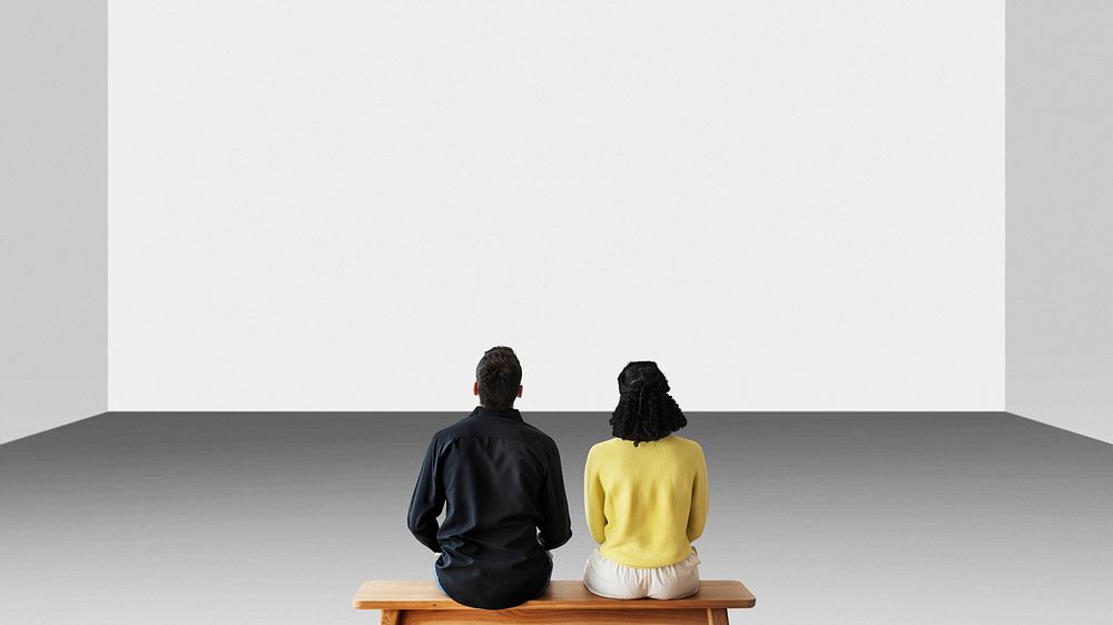 Couple looking at blank wall rear view