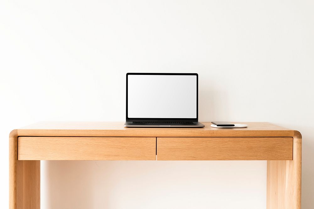 Laptop with blank screen on a wooden table