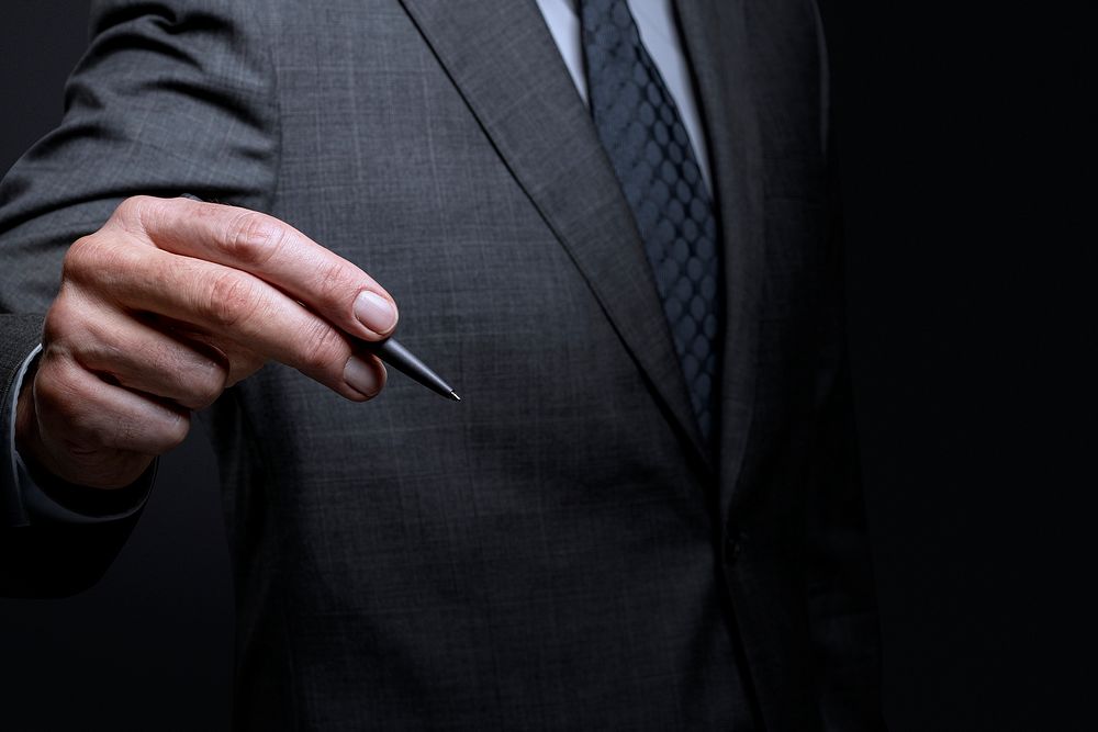 Businessman using a pen and signing on an invisible screen
