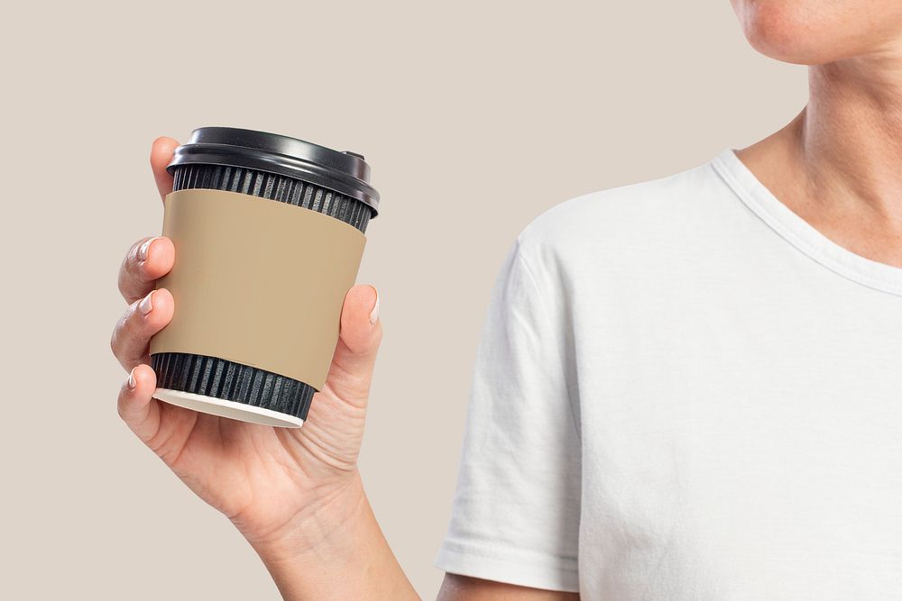 Woman holding a coffee cup with sleeve design space