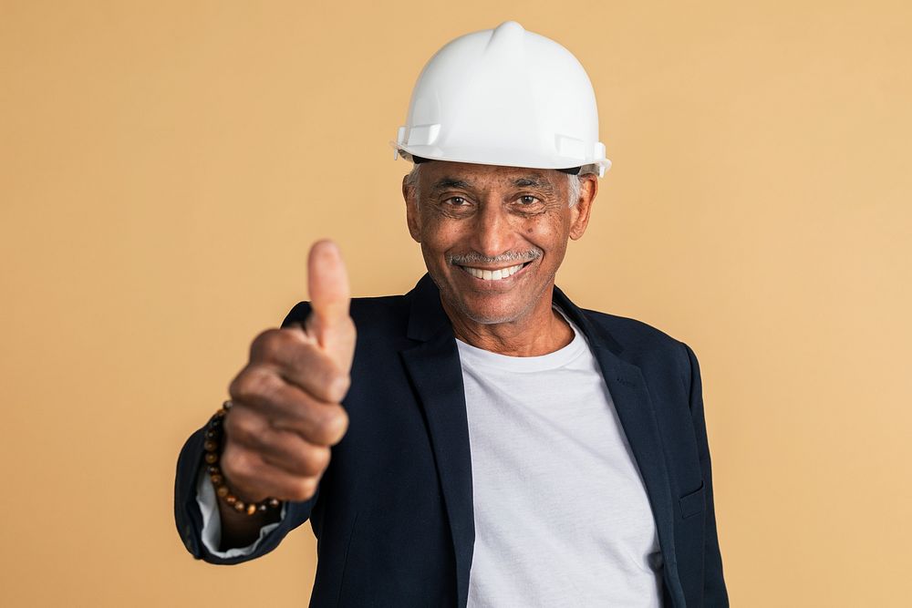 Mixed Indian engineer doing a thumbs up hand gesture 