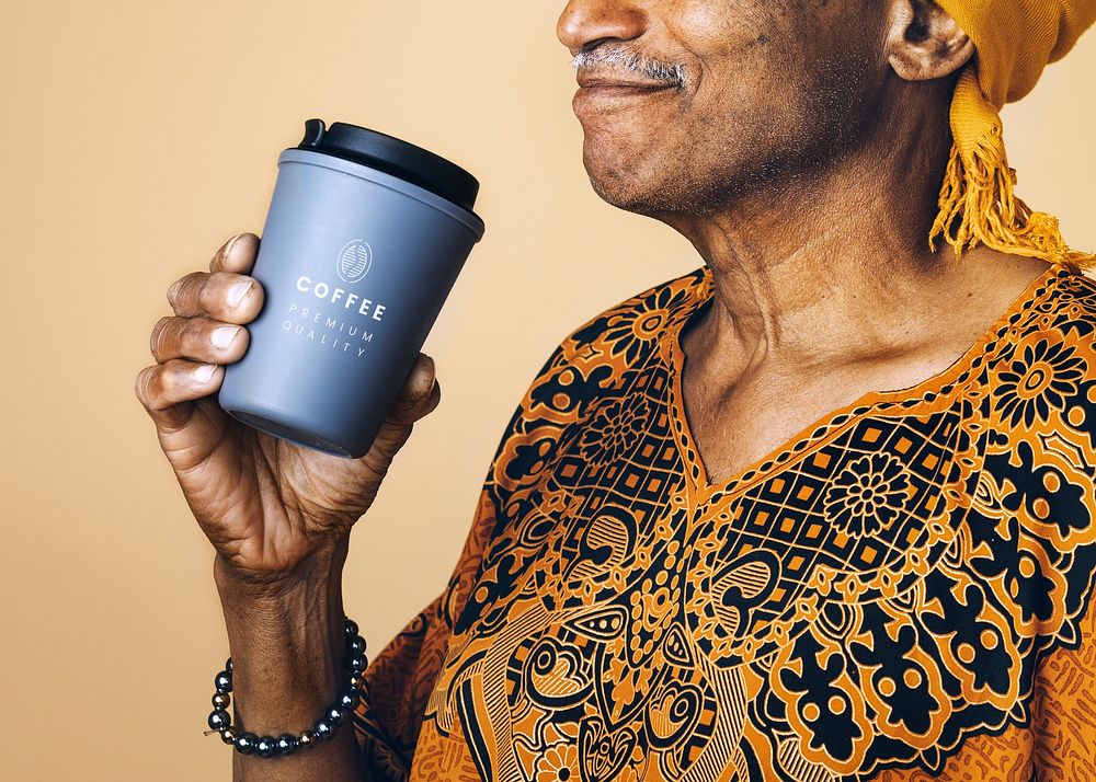 Senior mixed Indian man drinking coffee from a tumbler mockup 