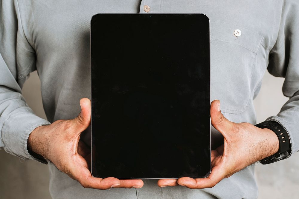 Businessman holding a digital tablet mockup 