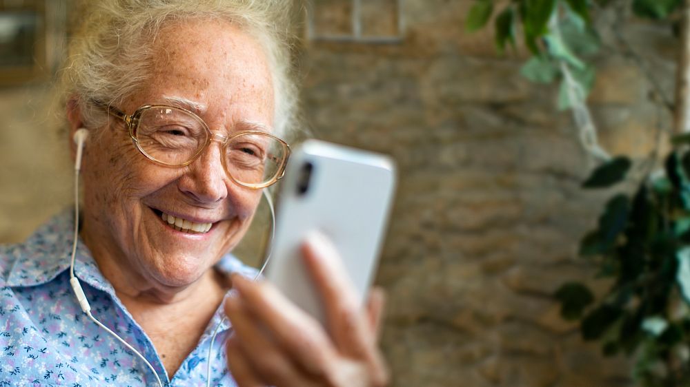 Senior woman smiling in video call in the new normal