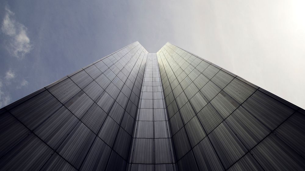 A low-angle shot of the gray facade of a skyscraper. Original public domain image from Wikimedia Commons