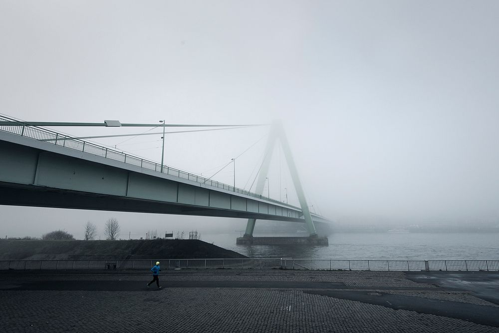 A view of a suspension bridge on a foggy, misty day. Original public domain image from Wikimedia Commons