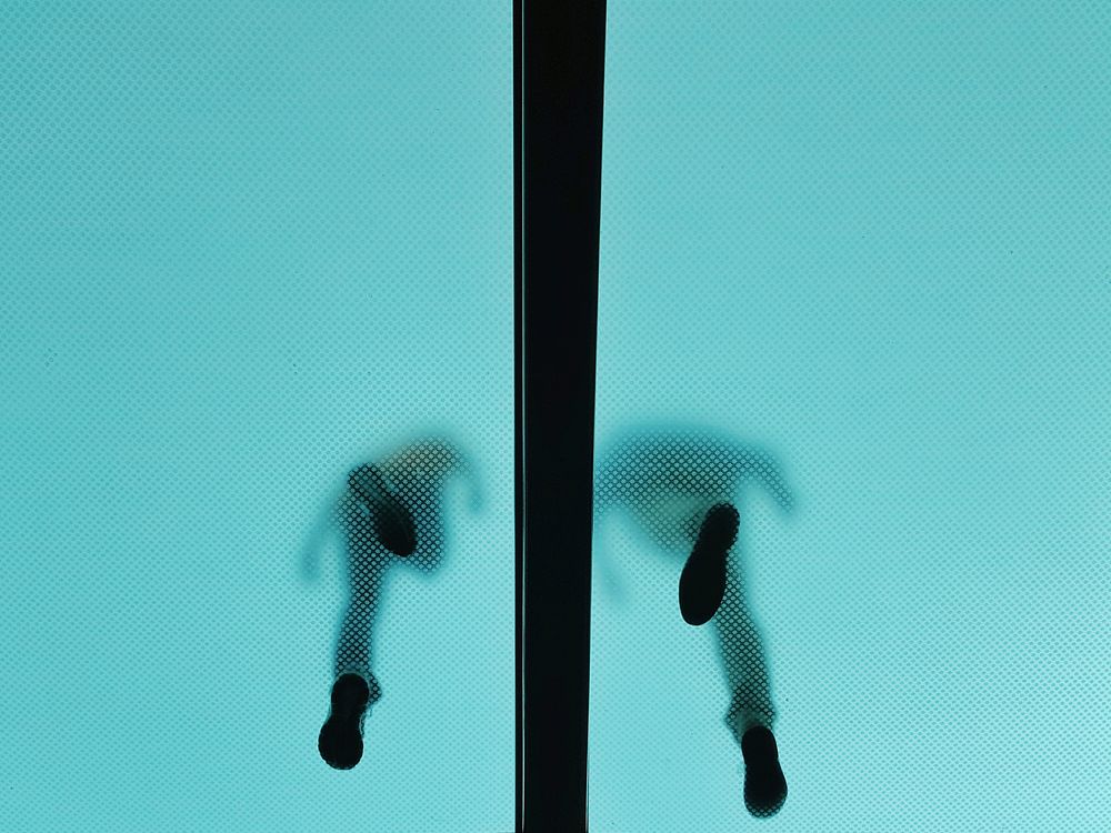 The shoeprints of two people walking on a level above seen through a translucent ceiling. Original public domain image from…