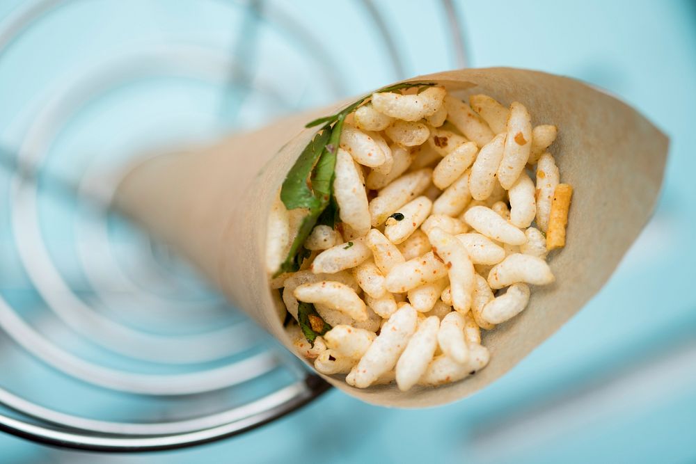 A puffed rice snack in a brown paper wrap. Original public domain image from Wikimedia Commons